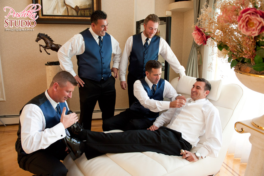 The Groomsmen and the Groom Groom's best man and friends helping him prepare for the big day