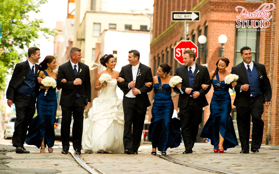 The Bridal Party Bride, groom, and bridal party walking in Dumbo