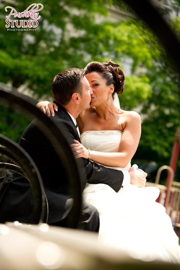 Brida and Groom on a bench in Dumbo Park Bride and Groom posing for a photograph, she is sitting on him