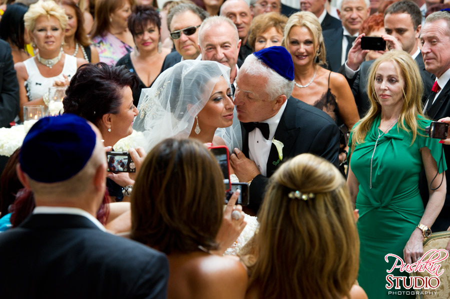 Father kissing bride at Wedding Ceremony Mother, father, and bride walking down the isle